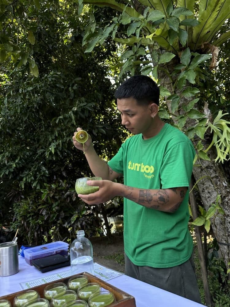 Whisking matcha under the trees at Chandra Yoga